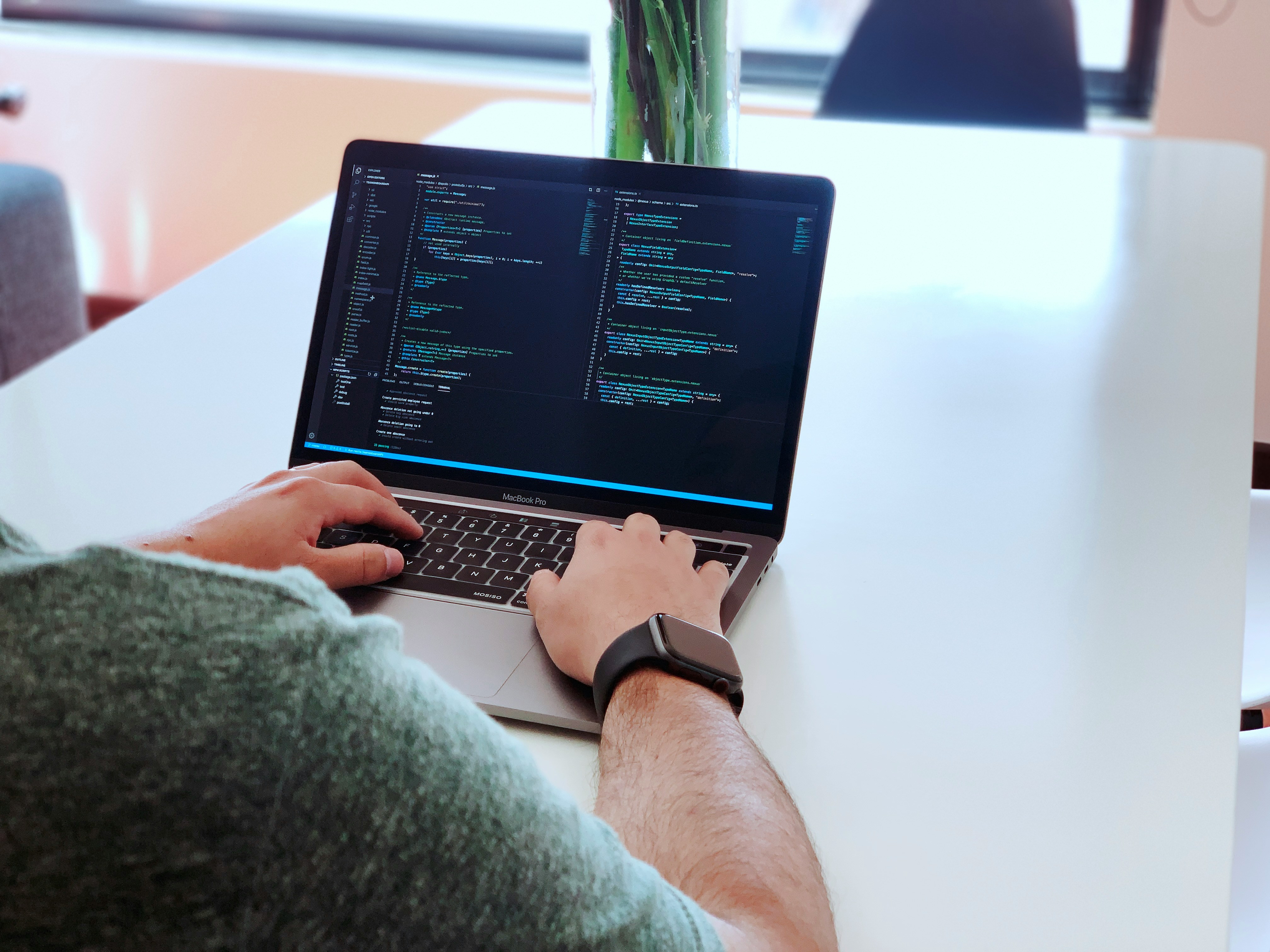 Developer workspace setup — clean desk, code on screen, tools of the trade
